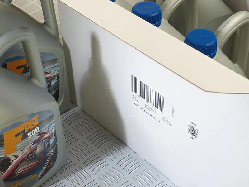 A group of car oil bottles inside a white porous cardboard box with a Cx150i code printed on the outside.